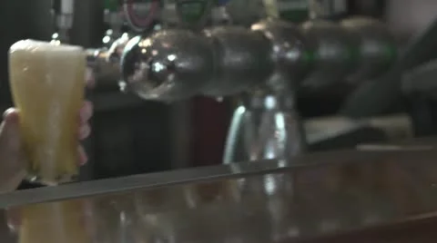 Frothy beer being served Stock Footage 20432611