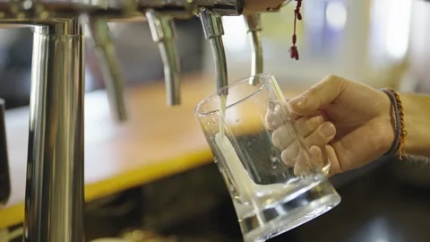 Frothy Beer Poured at a Bar Counter Stock Footage 308589763