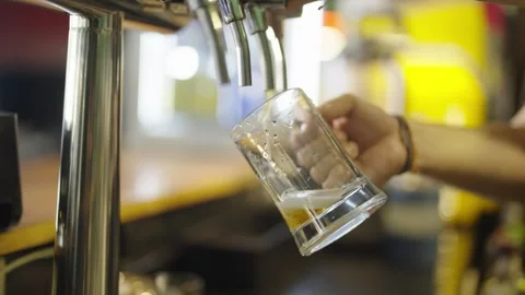 Frothy Beer Poured at a Bar Counter Stock Footage 308589907