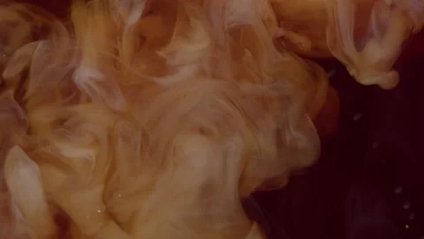 Frothy coffee drink poured into transparent glass. Layers mixing together. Stock Footage 199473779