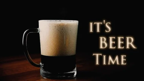 Frothy dark beer in glass Stock Footage 88561175