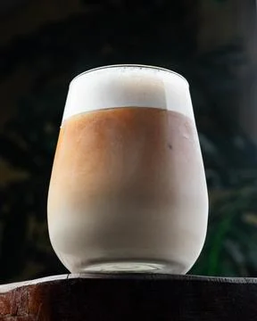 Frothy drink sits atop rustic wooden surface Stock Photos