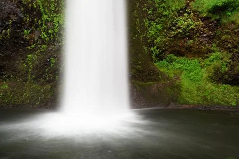Frothy falls into moss lagoon left Stock Photos