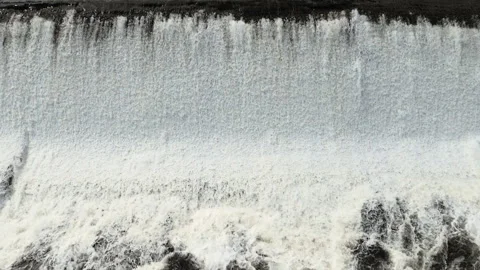 Frothy foaming waterfall stepped edge water feature. Stock Footage 99002329