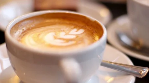 Frothy Latté Extreme Close-Up With Blurry Background Stock Footage 70736079