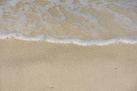 Frothy ocean water on beach Stock Photos