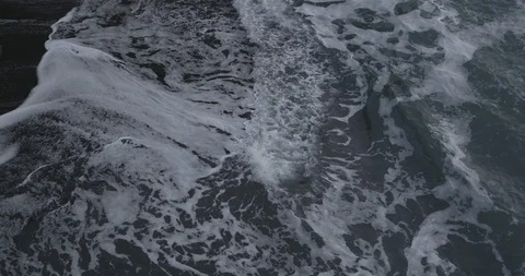 Frothy sea waves reaching the coast Stock Footage 103807854