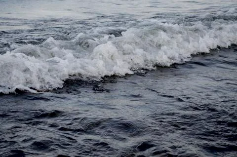 Frothy a tidal wave on the shore lakes Stock Photos