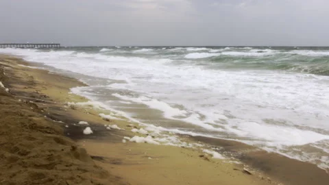 Frothy waves, beach foam, summer storm, long pier Stock Footage 195693565