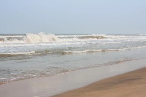 Frothy waves on beach Stock Photos