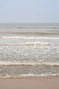 Frothy waves on beach Stock Photos