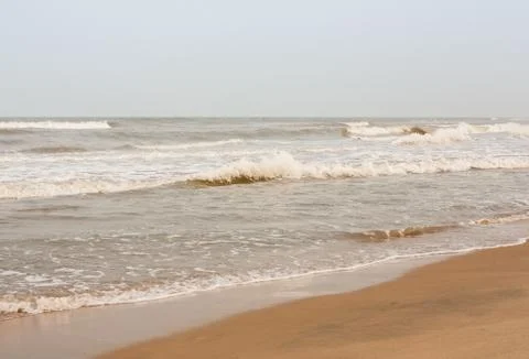 Frothy waves on beach Foto stock