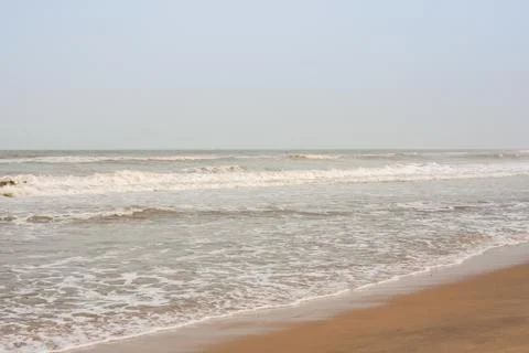 Frothy waves on beach Stock Photos