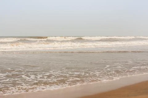 Frothy waves on beach Stock Photos