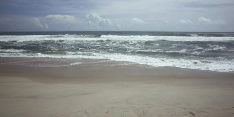 Frothy waves moving towards the sea coast Stock Footage 103493064