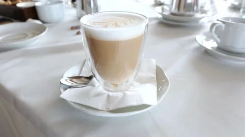 Frothy White Milky Coffee Latte or Cappuccino on White Table Stock Footage 158692724