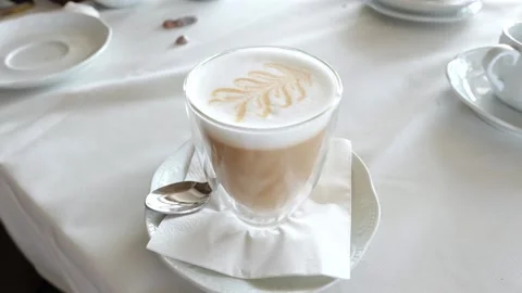 Frothy White Milky Coffee Latte or Cappuccino on White Table Stock-Footage 158692746