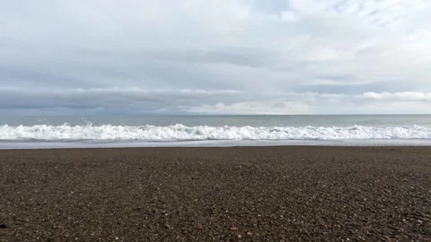 Frothy white sea wave flowing over sandy beach towards camera Stock Footage 303251955