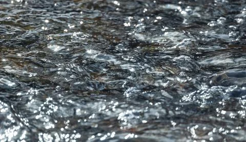 Frowing stream water surface with abstract ripple pattern Stock Photos