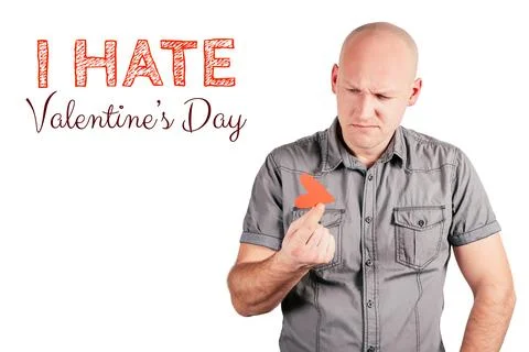 Frowning bald middle-aged man hold red heart with two fingers and inscription I Foto stock