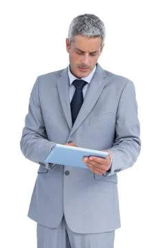 Frowning businessman using tablet pc Foto stock