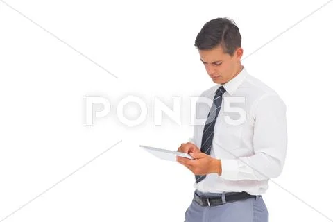 Frowning businessman using tablet Stock Photos