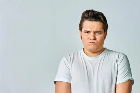 A frowning man on a gray background, copy space Stock Photos