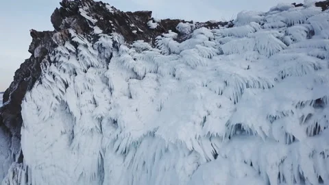 Frozen after winter storms, water splashes on the cliffs of the shore. Baikal. Stock Footage 107899410