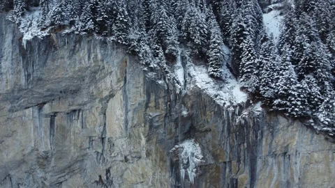 Frozen Alpine Majesty: 4K Drone View of Lauterbrunnen Waterfall, Switzerland Stock Footage 246609279