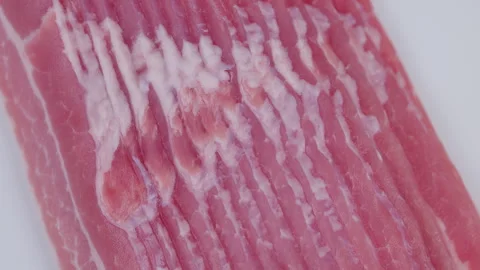 Frozen bacon closeup. Closeup image of frosted raw bacon with vivid pink tones. Stock Footage 331721491
