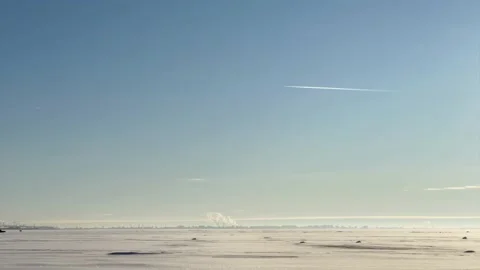 A frozen beach with clear sky and moving car Stock Footage 149596386