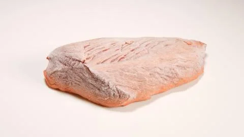 Frozen beef steak on white table Stock Photos