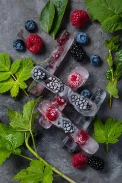 Frozen berries in ice cubes Stock Photos