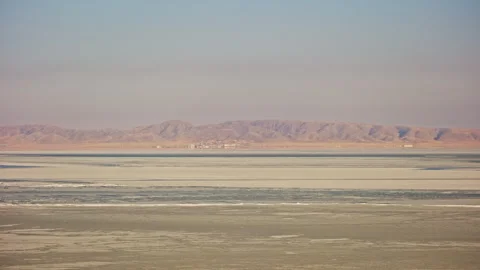 Frozen Blue Sea with Distant Mountain Range in Winter Stock-Footage 326437776