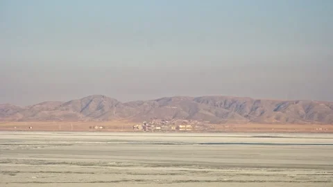 Frozen Blue Sea with Mountain Range and Small Village at the Coast Stock Footage 326373117