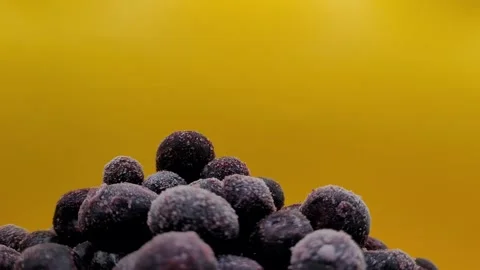 Frozen blueberries on a yellow background. Stock Footage 291176062