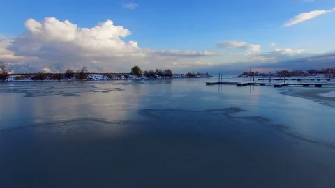 Frozen Boat Harbor Low Flyover with Lake Reveal and Clouds Vídeos de archivo 70867871