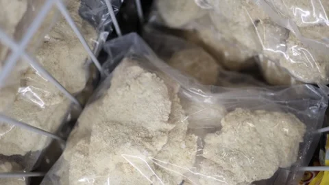 Frozen breaded food portions packed in plastic bags inside a freezer Vídeos de archivo 345979040