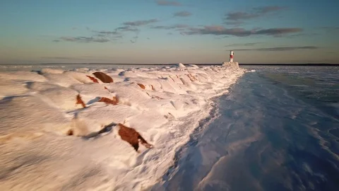 Frozen break wall and lighthouse Stock Footage 100135409