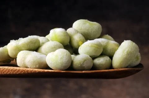 Frozen broad beans on the spoon. Stock Photos
