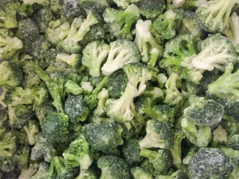 Frozen broccoli close-up. Green broccoli background. Stock Photos