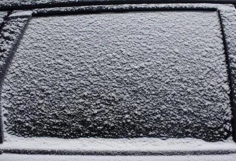 Frozen car side window in snow, texture freezing ice glass background Stock Photos