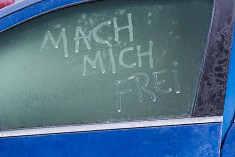 Frozen car window with a message text Stock Photos
