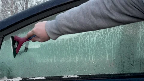 Frozen car windows. Clean off the ice Stock Footage 143583202