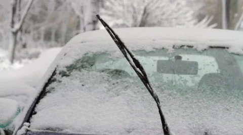 Frozen Car Windshield With Windshields Wipers Up in Blizzard, Pan Vídeos de archivo 45536659