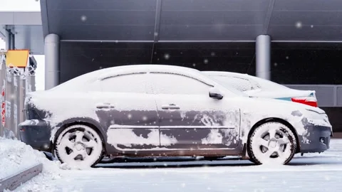 Frozen car in a winter day in the snowfall Stock Footage 99176535