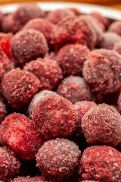 Frozen cherry fruit close up. Cherry in ice crystals. Stock Photos