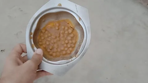 Frozen Chickpea Curry Held in a Hand Video stock 346937904