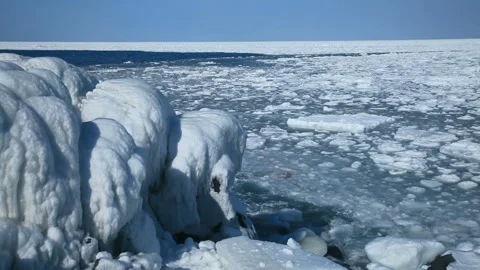 Frozen Coast and Drift Ice in the Spray Видео 332384883