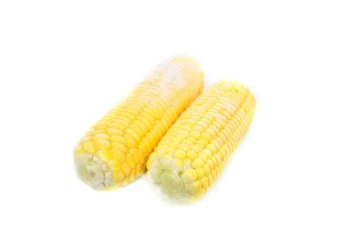 Frozen cobs of corn on white background. Shallow depth of field Stock Photos